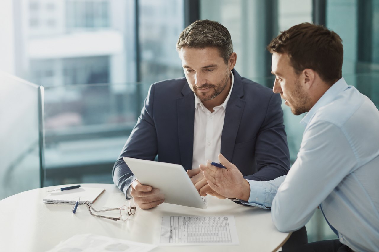An entrepreneur calculating company taxes with documents and a laptop on the desk